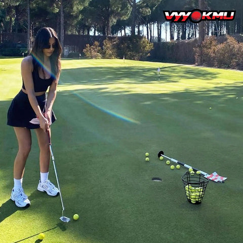 Woman practicing golf with a putter on a green with a Two Pack Golf Ball Basket With Handle, Portable Stainless Steel Buckets nearby