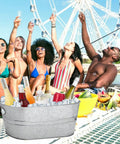 Two Pack 4 Gallon Galvanized Ice Buckets For Parties on a table with drinks during an outdoor gathering