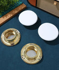 Built Tough Concealed Fire Sprinkler Ceiling Cover Plate With Slick Trim Ring Escutcheon in white and gold finish on a blue surface.