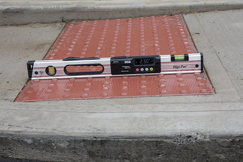 Waterproof IP65 Digital Level With Bright LED Display 24-Inch Pro Grade Electronic Level on pavement showing 2.50° reading
