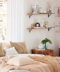 Pro Level Floating Wall Shelves Featuring Ridiculously Strong Metal Brackets And Zero Sag Particleboard Design For Bedroom Storage Or Bathroom Display Plus Straight Up Easy Hanging That Holds Up To 22 Pounds With Ease in a cozy bedroom setting.