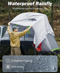 Man setting up 8-Foot Pickup Truck Bed Tent For Two, Double Layer Waterproof Shelter With PU2000mm Rating, gray rainfly visible