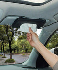Sleek Genuine Leather Car Tissue Holder Sun Visor Napkin Dispenser in use, hand retrieving napkin from sun visor.