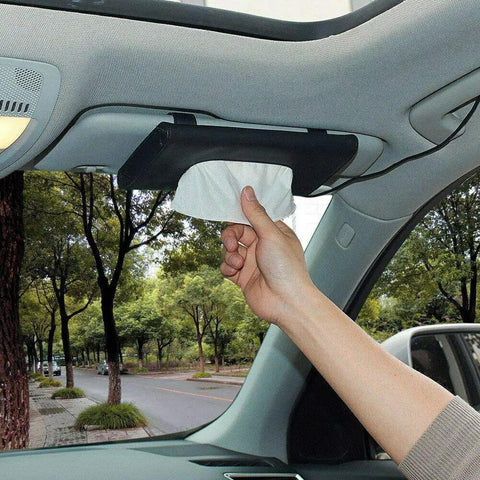 Sleek Genuine Leather Car Tissue Holder Sun Visor Napkin Dispenser in use, hand retrieving napkin from sun visor.