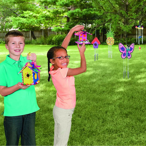 Kids enjoying Paint Your Own Wood Wind Chimes Craft Kit With Twelve Unfinished Wind Chimes Featuring Circle Heart And Star Designs For Kids Aged Four To Eight A DIY Arts And Crafts Activity For Parties And Creative Projects outdoors, showing decorated chimes.