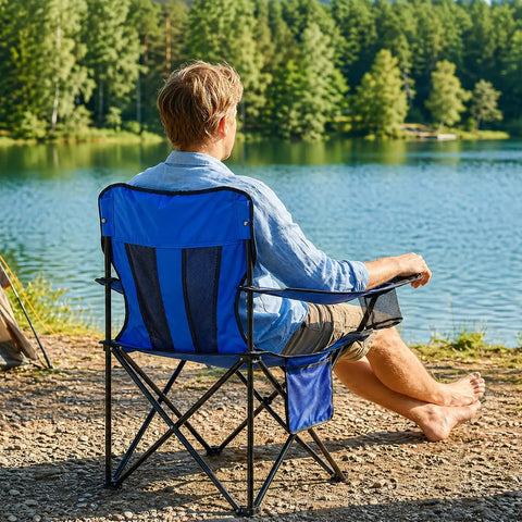 Man sitting by a lake on Two Pack Heavy Duty Folding Camping Chairs With 4 Can Cooler Bag And Cup Holder, Breathable Mesh Back, Blue