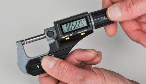 Hands using Xtra Value Ii Digital Micrometer Gage With 0 To 1 Inch Range And 0 To 25 mm Pro Grade Carbide Tipped Faces Flat Anvil