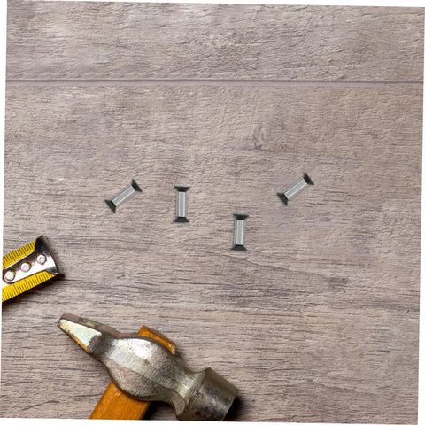 Knife handle rivets, four pieces, stainless steel; top-down close-up with hammer and measuring tape on wood surface.