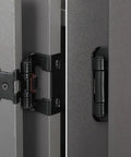 Close-up of 25 Pair Set of Self-Closing Half Inch Overlay Cabinet Hinges in Black, attached to a face frame cabinet.