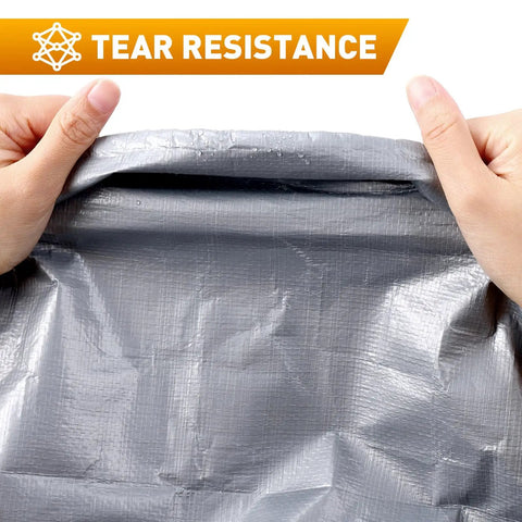 Hands demonstrating tear resistance of Heavy Duty Waterproof Camping Tarp 10x20 Ft Thick 16 Mil With 15x17 Weave.