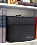 Ultra Lightweight Fireproof Document Safe Under 2 Lbs Portable Home Security Safe With Lockable Zipper on bookshelf