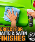 Hand applying Meticulous Matte Detailer And Spray Sealant For Crisp Satin And Matte Finishes Safe For OEM Vinyl And Painted Matte Surfaces 32 Fl Oz Easy Spray Application Non Greasy Matte Coating Streak Free Protection For Your Daily Driver to green car with cloth