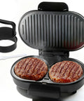 FineMade Double Mini Grill Maker, Breakfast Sandwich Press And Burger Patty Mold grilling two burger patties with nonstick plates.