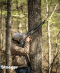 Hunter aiming XM1 Scout Compact PCP Air Rifle Caliber Twenty Five With Black Synthetic Stock in forest setting