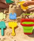 Epic Beach Toy Set For Kids with folding bucket, animal shovels, rakes, molds in sand play setting