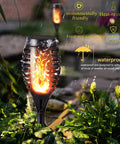 Outdoor Halloween Lights Four Pack LED Torch Lanterns with Flickering Flame Effect in garden setting under rain.