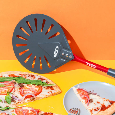 TKC 9-inch perforated aluminum pizza peel with red long handle; gray slotted disk for turning pizzas.