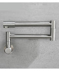 Foldable Wall-Mount Kitchen Faucet - Brushed Stainless Steel showing expandable and retractable design on a gray surface.