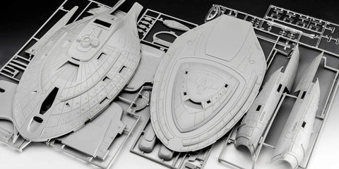 Unassembled U.S.S. Voyager 1:670 scale Intrepid-class model kit components on sprue, detailed plastic surface parts visible.
