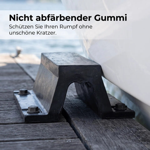 Beefed-Up Rubber Dock Protector With Arch Bolt-Down Mount securing a wooden dock, beside a boat, showing weatherproof marine shield.