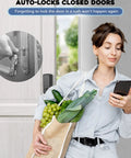 Woman using phone near keyless front door lock set with handle, app controlled fingerprint door lock, 150 codes keyed entry smart deadbolt, auto lock, backlit.