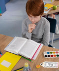 Child studying at desk with Black And White Pencil Name Tag Stickers Set 250 Pieces For Back To School Classroom Bulletin Boards.