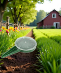 Adjustable Seed Dispenser Hand Tool for Garden Planting and Sowing in a garden bed with flowers and farmhouse background