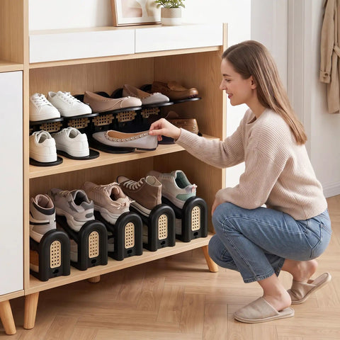 Woman organizing shoes using 12 Pack Adjustable Shoe Slot Organizers, Double Layer Closet Stackers in black.