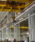 Industrial warehouse interior with overhead crane setup and metal structures, showcasing Dual Fuel Low Intensity Radiant Tube Heater Packing 100000 BTU Power.