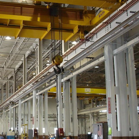 Industrial warehouse interior with overhead crane setup and metal structures, showcasing Dual Fuel Low Intensity Radiant Tube Heater Packing 100000 BTU Power.