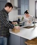 Man using EZ Start Clear Packing Tape Refills For Shipping Moving And Storage 6 Rolls 1.88 Inch By 55 Yards on kitchen counter