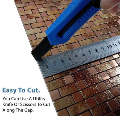 Cutting Self Adhesive Aluminum Mosaic Backsplash Tiles Five Sheet Set for Kitchen Walls and More with a utility knife.