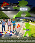 Kid Alert Street Safety Sign 31 Inch Green Caution Sign For Neighborhoods And Schools, Slow Down Kids At Play With Reflective Slow Sticker And Warning Flag, High Visibility Safety Sign placed outdoors near children playing.