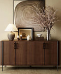 Mid-century modern sideboard with decor, featuring a lamp, art pieces, and dried flowers in a stylish interior setup.