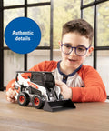 Child playing with Bobcat 1/16 Scale Skid Steer Loader Diecast Toy With Fully Functional Front Loader And Tilt Bucket Realistic Bobcat Graphics Rubber Wheels Built Tough For Kid Friendly Play And Collectors Ages Three And Up indoors.