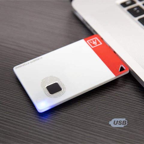 ATKey Card Fingerprint Security Key With FIDO2 Certification USB A NFC And Bluetooth For Online Accounts Including Azure Microsoft 365 Google Salesforce Facebook Twitter Apple And More next to laptop