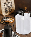 Rotating Cup Dispenser With Four Compartments And Lid Holder 360 Degree Tray Holds 3 To 16 Oz Disposable Cups Countertop Organizer in white.