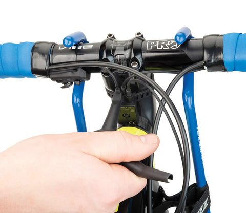 Person using EWS1 Electronics 3 Way Tool For Bike Systems With Angled Di2 E Tube Ends For Tight Space Install And Removal on handlebars.