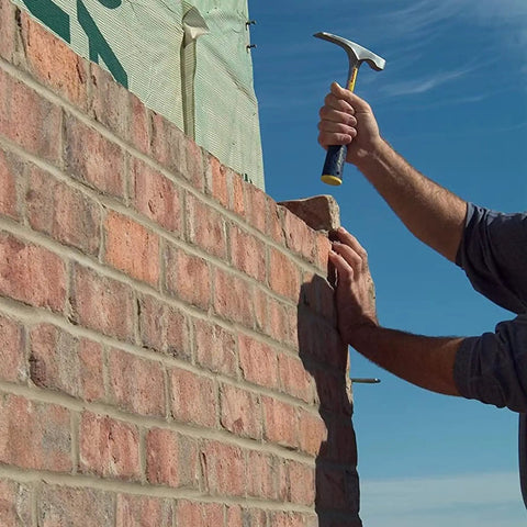 Person using Bricklayer And Mason Hammer 16 Oz USA Made Built Tough Pro Grade Masonry Tool With Forged Steel on brick wall
