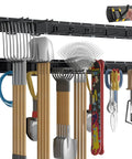 Wall Mount Garage Tool Organizer With 48 Inch Rails And 7 Adjustable Beefy Heavy Duty Hooks holding garden tools and accessories.