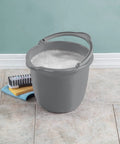 10 Qt Titanium Spout Pail Mop Bucket With Pour Spout And Comfort Grip Handle next to cleaning brush and sponge on tiled floor