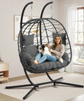 Woman sitting with dog in Double Egg Chair With Stand For Indoor Or Outdoor Use, Two Person Hanging Swing, Grey Cushions