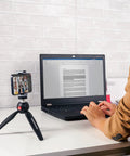 PIXI Mini Tripod With Handgrip for Compact System Cameras, DSLRs and Mirrorless on desk with smartphone attached