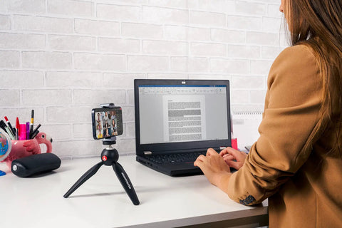 PIXI Mini Tripod With Handgrip for Compact System Cameras, DSLRs and Mirrorless on desk with smartphone attached