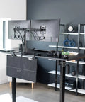 30 Inch Clamp On Desk Skirt With Privacy Panel And Cable Management System in black, attached under a standing desk, cords tucked away