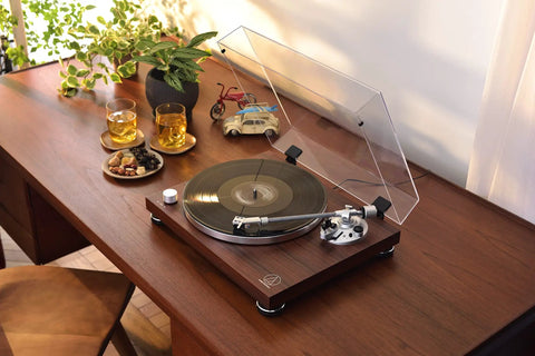 Audio-Technica At-Lpw50bt-Rw Manual Belt-Drive Turntable In Slick Rosewood with Bluetooth on a wooden table