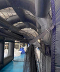 Interior view of Inflatable Tennis Court Style Tent And Baseball Batting Cage with blower, showing durable netting inside the frame.