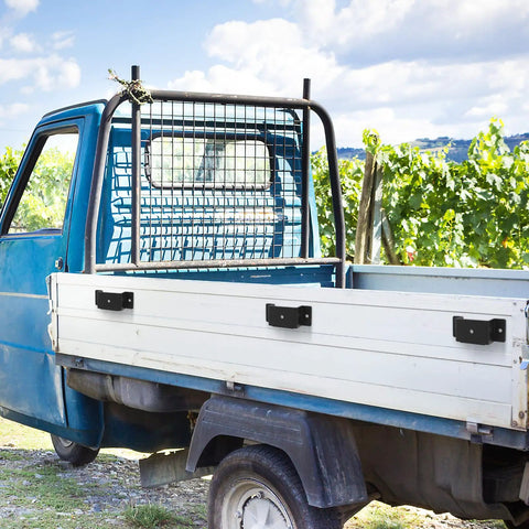 Rock Solid Trailer Stake Pocket Brackets 12 Pack Heavy Steel Inserts on a blue truck bed for secure load containment.