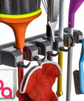 Close-up of Mop And Broom Wall Mount Organizer with 11 storage spots, holding cleaning tools, gray rack.
