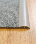 Close-up of 6.6 Ft Long Floor Transition Strip Edge Reducer for Rubber Wood Tile and Carpet Floors Beveled Ramp Threshold Edging Vinyl Trim